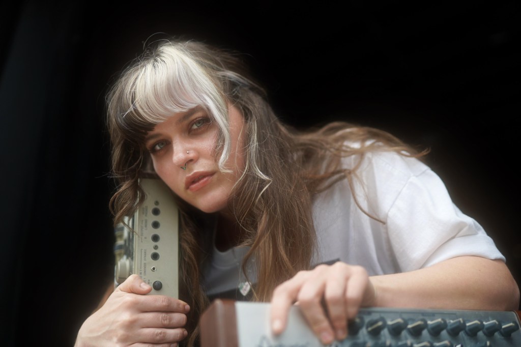 Taylor Wafford of Blood Root poses with a soundsystem board.