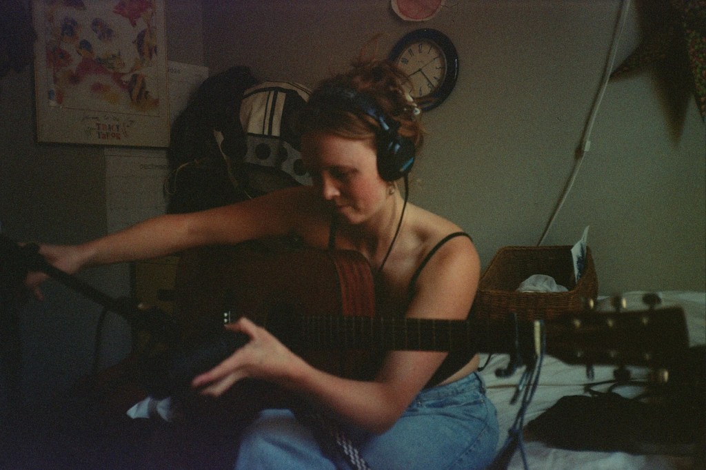 Winefred RT playing the guitar.