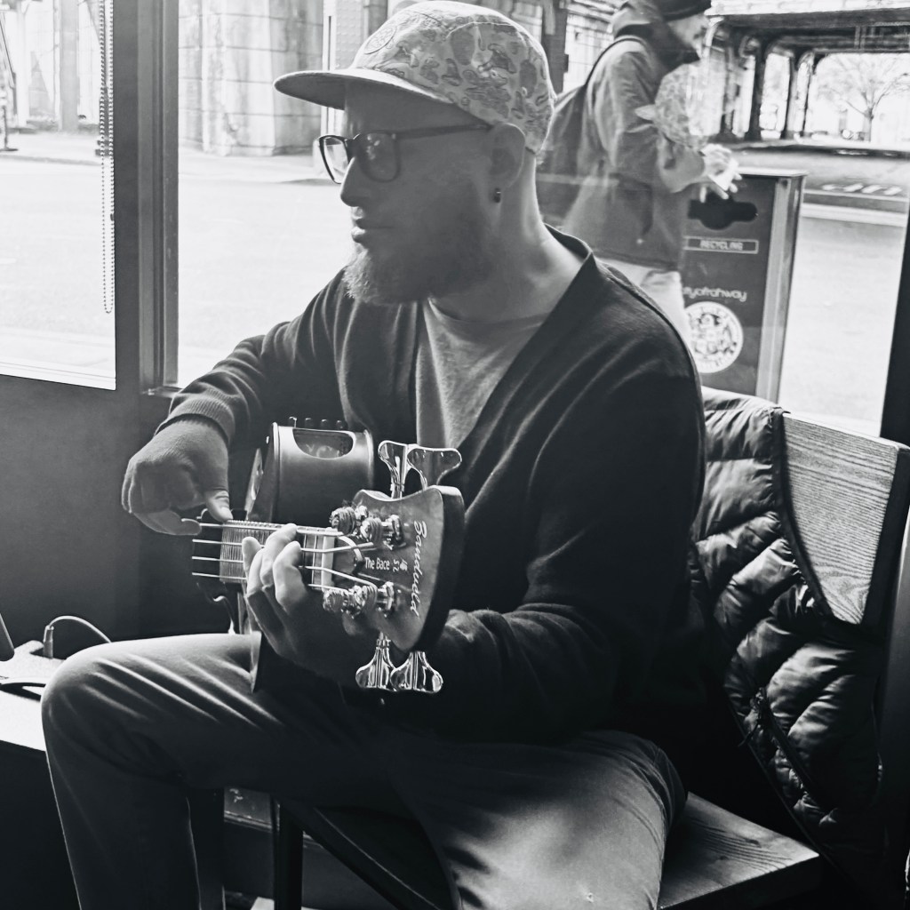 Billy Carrión playing the bass guitar.