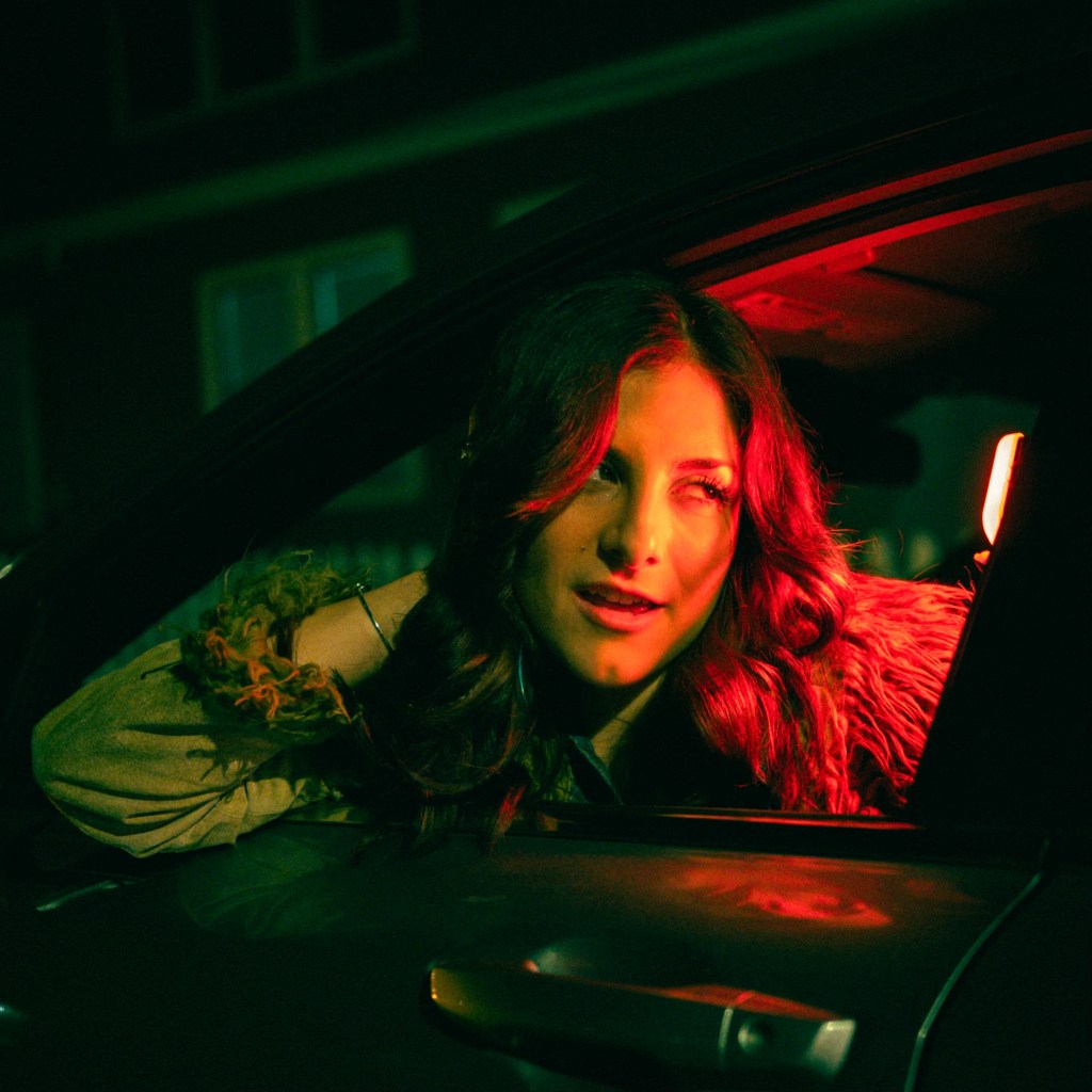 Kelsey Blackstone leaning out of a car