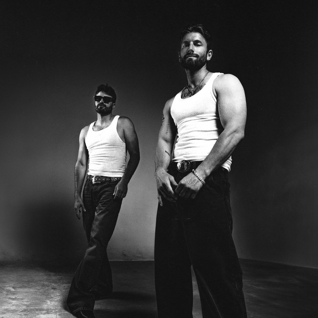 NO HArD FEELINGS by Marc E. Bassy and Nic Nac album cover. Two white men stand wearing white tank tops and black jeans in a black-and-white photograph against a blank background.