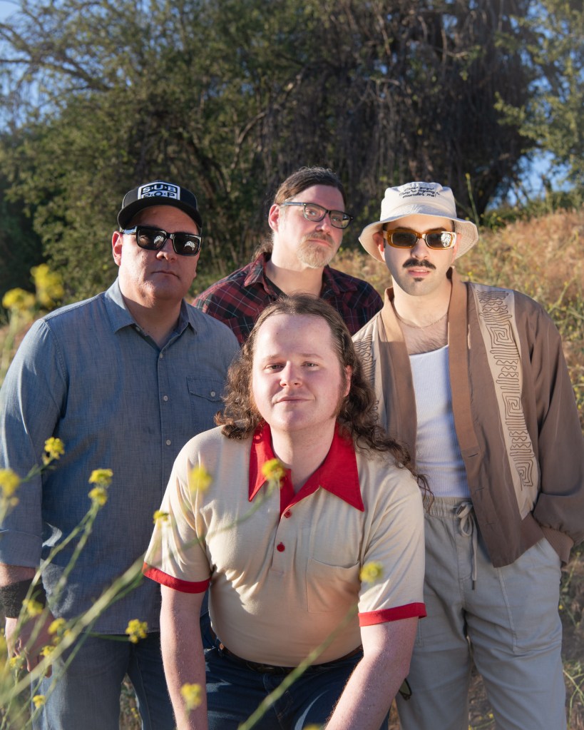 Sam Slick photographed with his band for the release of "After the Dream, Before the Memories"