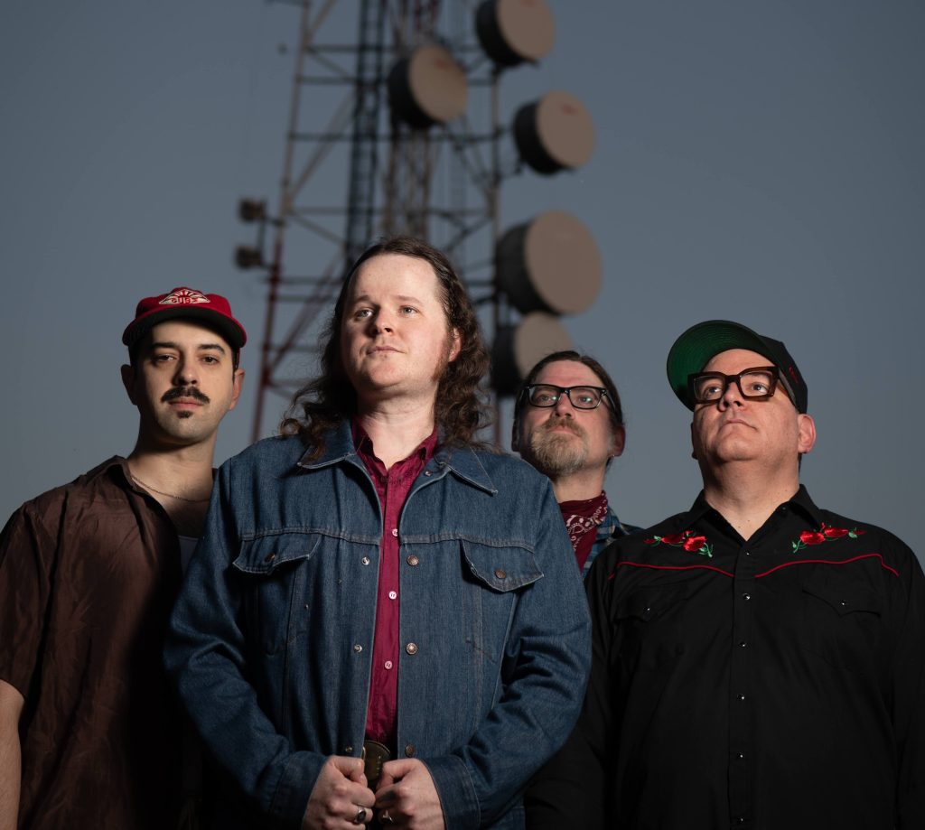 Sam Slick photographed with his band for the release of "After the Dream, Before the Memories"