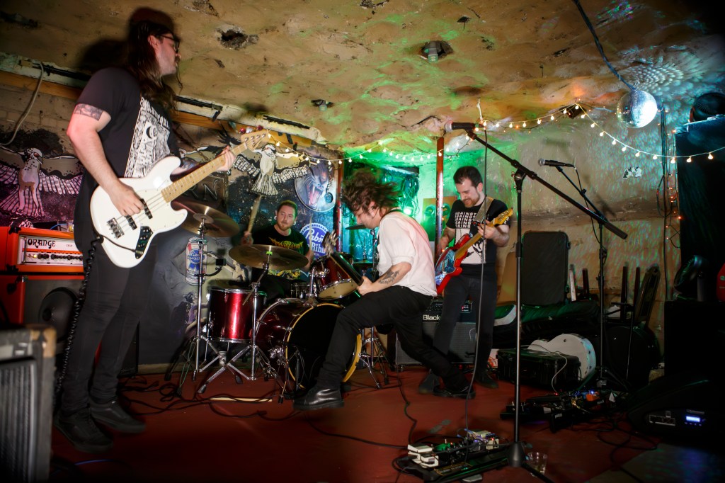 Bobby Mahoney and his band performing live in what appears to be an underground stage