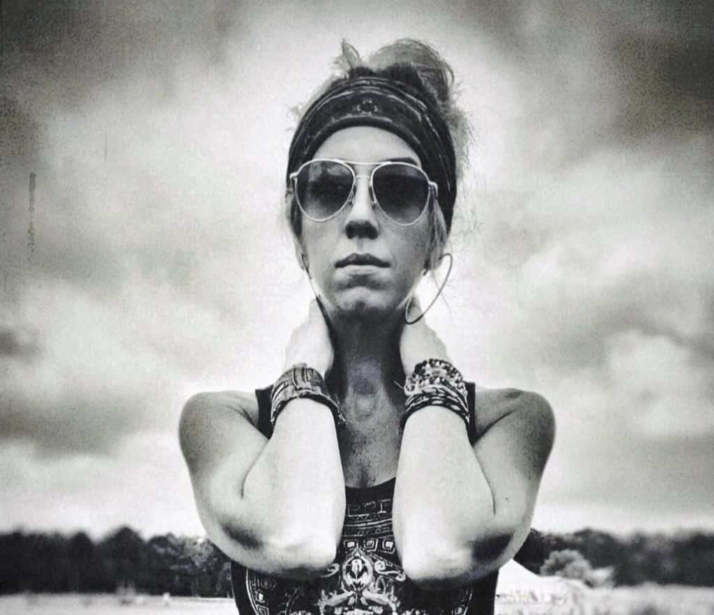 Sandi Joy pictured in front of a cloudy sky